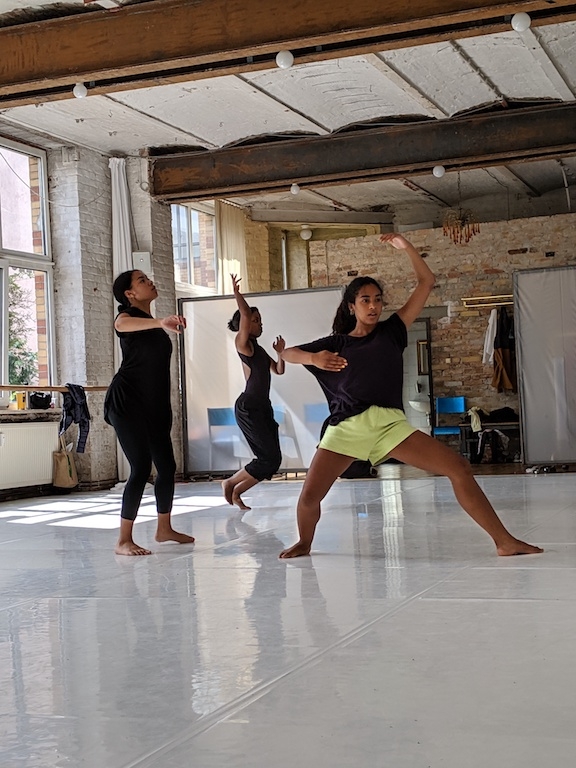 Dancer posed with legs spread wide during studio training.